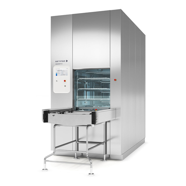 Large industrial sterilizer with an open chamber and control panel, designed for medical equipment cleaning.